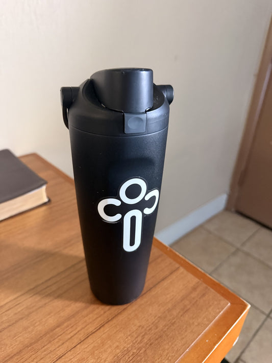 CiC white cross sticker on a black water bottle